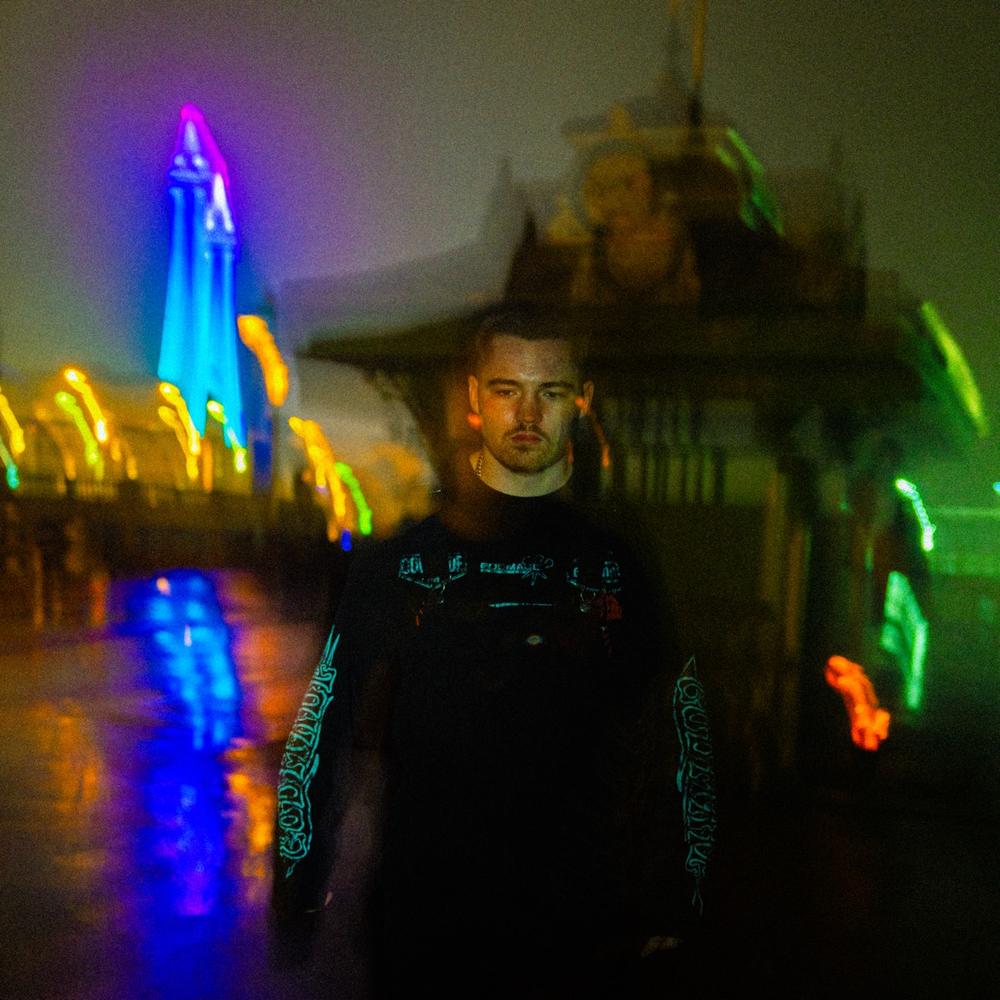 Roman Ellis walking the Blackpool prom under the Illuminations